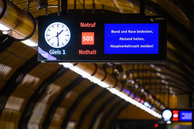 (200428) -- MUNICH, April 28, 2020 (Xinhua) -- A screen notifying passengers to cover their mouths and noses, keep distance and avoid traveling during rush hours is seen at a subway station in Munich, Germany, April 27, 2020. In most German states, face masks or an equivalent mouth-and-nose cover have become mandatory on Monday when people travel by bus or train or go shopping. (Photo by Kevin Voigt Xinhua) GERMANY-MUNICH-COVID-19-FACE MASK 