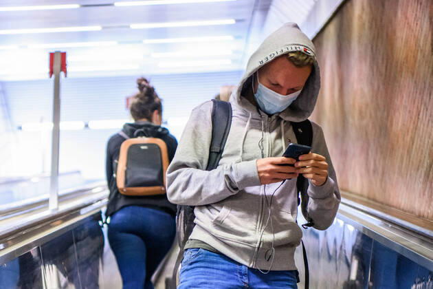 (200428) -- MUNICH, April 28, 2020 (Xinhua) -- A man wearing a face mask looks at his cellphone at a subway station in Munich, Germany, April 27, 2020. In most German states, face masks or an equivalent mouth-and-nose cover have become mandatory on Monday when people travel by bus or train or go shopping. (Photo by Kevin Voigt Xinhua) GERMANY-MUNICH-COVID-19-FACE MASK 