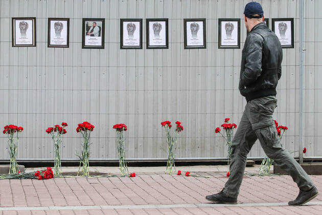 ST PETERSBURG, RUSSIA - APRIL 28, 2020: A man walks past portraits of medical workers who died after contracting the novel coronavirus by the offices of St Petersburg s Healthcare Committee in Malaya Sadovaya Street. The wall of memory was created by St Petersburg resident Irina Maslova. Peter Kovalev TASS  TS0D7524