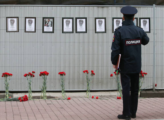 ST PETERSBURG, RUSSIA - APRIL 28, 2020: A police officer by portraits of medical workers who died after contracting the novel coronavirus by the offices of St Petersburg s Healthcare Committee in Malaya Sadovaya Street. The wall of memory was created by St Petersburg resident Irina Maslova. Peter Kovalev TASS  TS0D752B