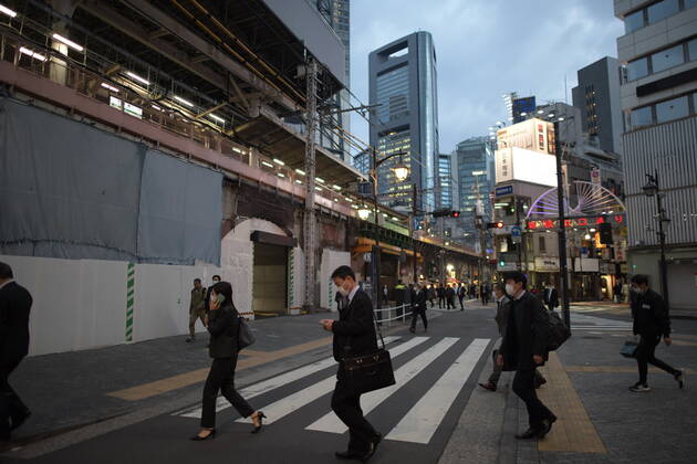 TOKYO, JAPAN - APRIL 28: Commuters wearing face masks head back home after work in Tokyo s financial district amid concerns of the COVID-19 coronavirus outbreak on Tuesday, April 28, 2020. Japanese Prime Minister Shinzo Abe declared a nationwide State of Emergency last week urging people to stay home to prevent the spread of the coronavirus throughout the country. (Photo: Richard Atrero de Guzman AFLO) (125786462)