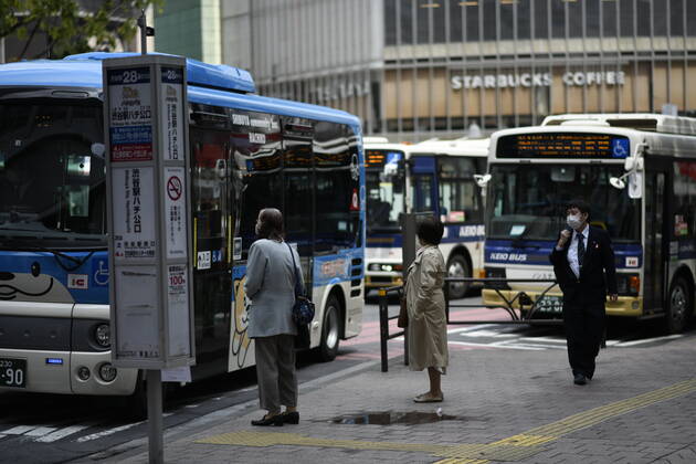 TOKYO, JAPAN - APRIL 28: Commuters wearing face mask is seen waiting a bus in Tokyo amid concerns of the COVID-19 coronavirus outbreak on Tuesday, April 28, 2020. Japanese Prime Minister Shinzo Abe declared a nationwide State of Emergency last week urging people to stay home to prevent the spread of the coronavirus throughout the country. (Photo: Richard Atrero de Guzman AFLO) (125786494)