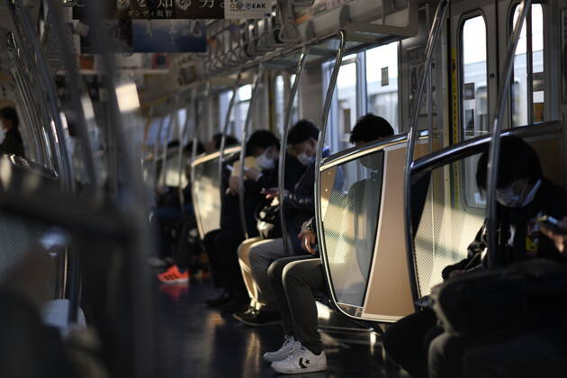 TOKYO, JAPAN - APRIL 28: Commuters wearing face masks head to work in Tokyo amid concerns of the COVID-19 coronavirus outbreak on Tuesday, April 28, 2020. Japanese Prime Minister Shinzo Abe declared a nationwide State of Emergency last week urging people to stay home to prevent the spread of the coronavirus throughout the country. (Photo: Richard Atrero de Guzman AFLO)  (125786496)