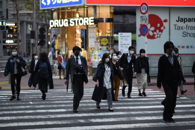 TOKYO, JAPAN - APRIL 28: Commuters wearing face masks heading back home after work in Tokyo s financial district amid concerns of the COVID-19 coronavirus outbreak on Tuesday, April 28, 2020. Japanese Prime Minister Shinzo Abe declared a nationwide State of Emergency last week urging people to stay home to prevent the spread of the coronavirus throughout the country. (Photo: Richard Atrero de Guzman AFLO) (125786523)