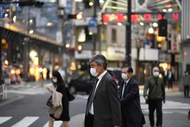 TOKYO, JAPAN - APRIL 28: Commuters wearing face masks head back home after work in Tokyo s financial district amid concerns of the COVID-19 coronavirus outbreak on Tuesday, April 28, 2020. Japanese Prime Minister Shinzo Abe declared a nationwide State of Emergency last week urging people to stay home to prevent the spread of the coronavirus throughout the country. (Photo: Richard Atrero de Guzman AFLO)  (125786526)