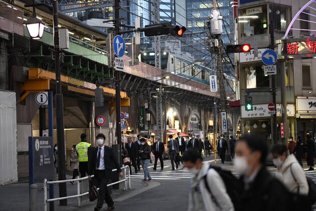 TOKYO, JAPAN - APRIL 28: Commuters wearing face masks head back home after work in Tokyo s financial district amid concerns of the COVID-19 coronavirus outbreak on Tuesday, April 28, 2020. Japanese Prime Minister Shinzo Abe declared a nationwide State of Emergency last week urging people to stay home to prevent the spread of the coronavirus throughout the country. (Photo: Richard Atrero de Guzman AFLO) (125786527)