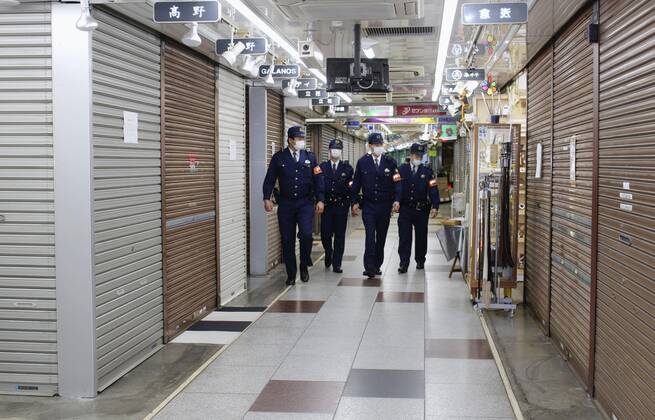 New coronavirus Police officers patrol Tokyo s Ameyoko shopping area on April 28, 2020, amid the coronavirus pandemic. 