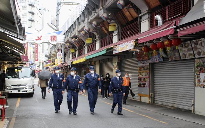 New coronavirus Police officers patrol Tokyo s Ameyoko shopping area on April 28, 2020, amid the coronavirus pandemic. 