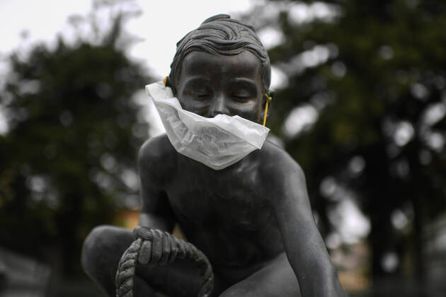 A protective mask is placed on a statue of a child fisherman, in street riviera, in Naples city. Government Decree declaring all of Italy a protected area to combat Covid-19 - Coronavirus infection.  Copyright: xSalvatorexLaportax xIPAx xKontrolabx