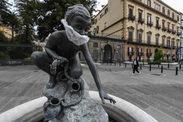 A protective mask is placed on a statue of a child fisherman, in street riviera, in Naples city. Government Decree declaring all of Italy a protected area to combat Covid-19 - Coronavirus infection.  Copyright: xSalvatorexLaportax xIPAx xKontrolabx