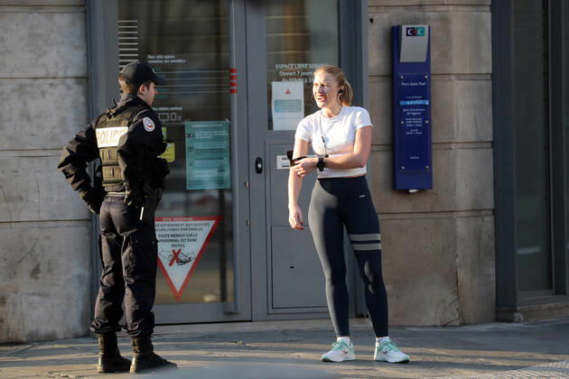 Security forces check residents permits to be in the streets of Paris, France, Tuesday April 28, 2020 as country enters its 6th week of confinement. The French premier announced today that protective masks, which have been in severe shortage since the outbreak of the pandemic, will be available for everyone starting May 11th.  PAR20200428107 ECOxCLEMENT