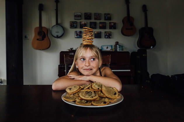 IMAGO Creative: Jahreszeit Winter, Fantasievoll drinnen spielen Young girl balancing cookies on her head Windsor, ON, Canada CR_JEOH200518-377581-01,model released, Symbolfoto