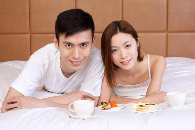 A couple enjoying life in a hotel room 55295075424535909