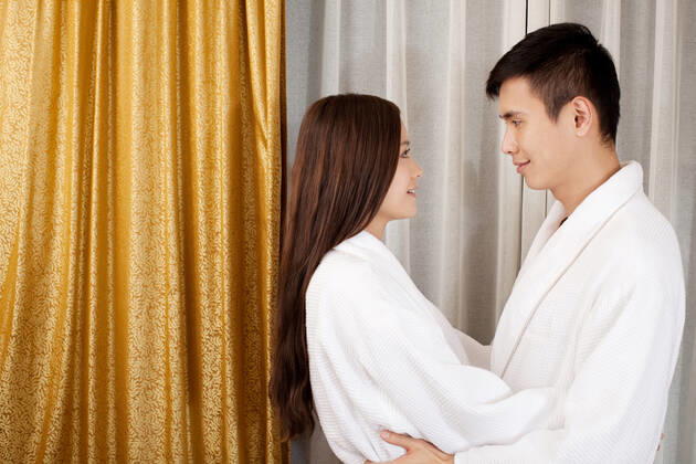 A couple enjoying life in a hotel room 55295075424535973