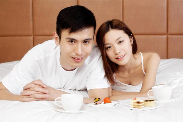 A couple enjoying life in a hotel room 55295075424538312