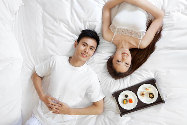 A couple enjoying life in a hotel room 55295084014470443