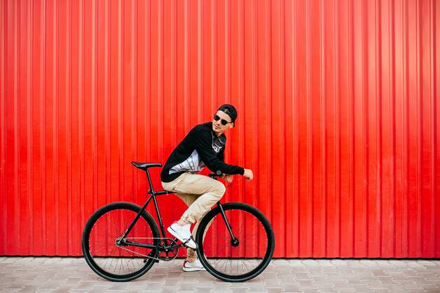  Trendy man sitting on bike, looking back, on the street Copyright: xazovtcev161x Panthermedia27173106 ,model released, Symbolfoto