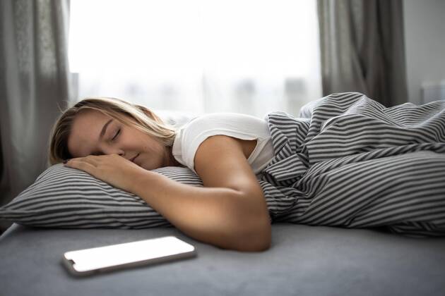  Pretty, young woman sleeping in her bed with her cell phone close to her. Smartphone in Bed Mobile/smartphone Addiction Concept. Copyright: xLightpoetx Panthermedia27965290 ,model released, Symbolfoto