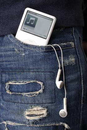 An Apple iPod with headphones sticking out of teenager s pocket, fashion, in ripped up jeans. (CTKxPhoto JosefxHorazny) CTKPhotoF200903040133401