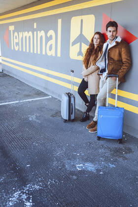 Confident business couple standing with luggage at airport terminal model released Symbolfoto EHF00432