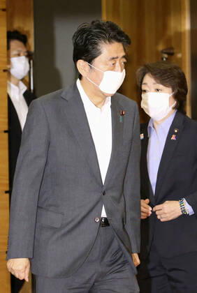 Japan PM Abe Japanese Prime Minister Shinzo Abe is pictured ahead of a Cabinet meeting at his office in Tokyo on July 31, 2020. Seen on the right is Olympic minister Seiko Hashimoto.