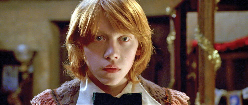 HARRY POTTER AND THE GOBLET OF FIRE RUPERT GRINT as Ron Weasley Date: 2005. Strictly editorial use only in conjunction with the promotion of the film. Credit line mandatory. This image is copyright of the film company and is supplied under the terms of issue as film still. No commercial or book cover use permitted without prior consent from the film company. Mandatory credit line: Image courtesy WARNER BROS & J K ROWLING Ronald Grant Archive Mary Evans