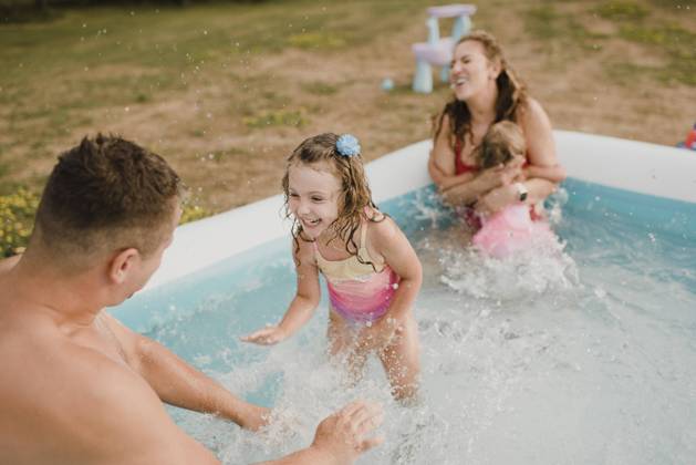 Happy family in an inflatable swimming pool in garden model released Symbolfoto property released SMSF00124