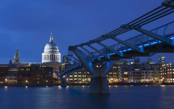 United Kingdom, England, London, View of Millennium Bridge with St Pauls Cathedral in background at night JB000013