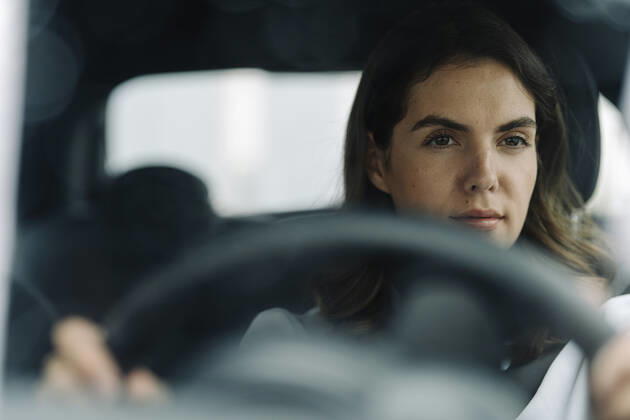 Young woman driving car model released Symbolfoto KNSF08521