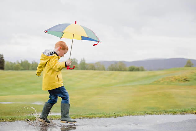 Creative Highlights Symbolfotos Redheaded little boy with umbrella playing in the rain model released Symbolfoto NMS00298
