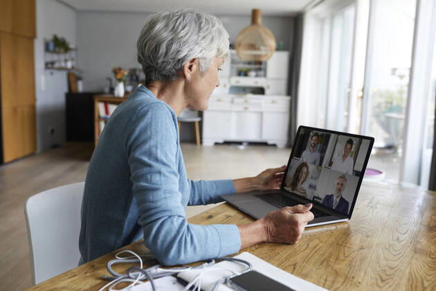 Active senior woman attending meeting on video conference while sitting at home model released Symbolfoto property released RBF07869