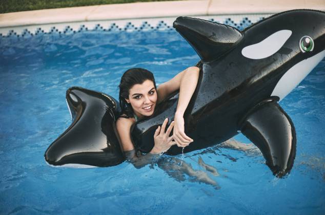Girl with inflatable toy posing in water, Model released, Property released Copyright: xEduardoxHuelinx MR