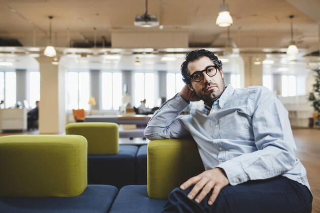 Portrait of mature man sitting on couch at corridor , model released Copyright: xMaskotx , MA49349