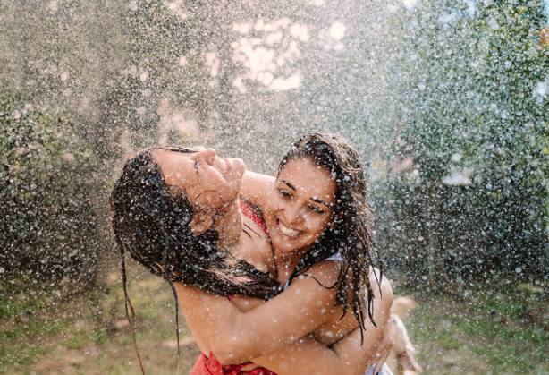 Friends in swimsuits hugging under water drops, Model released Copyright: xGabrielxTrujillox MR