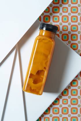 Mango and pumpkin smoothie bottle over retro style geometric textures. From above, Model released, Property released Copyright: xJayxMidx MR