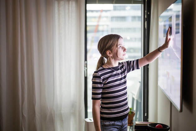 Girl touching digital display of television set at modern home Sweden, Stockholm, model released, property released Copyright: xMaskotx , MA80375