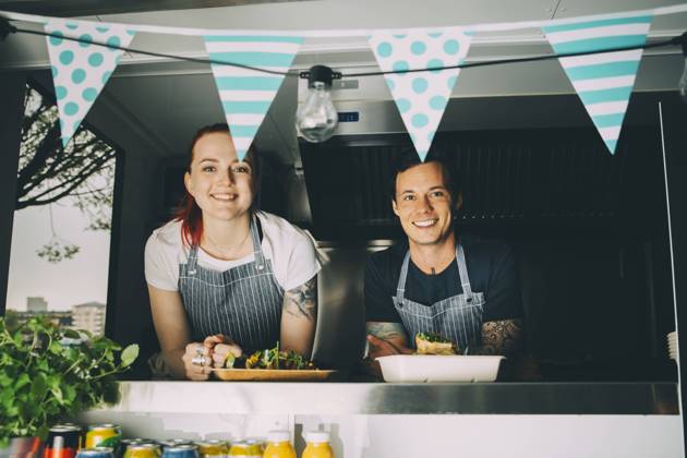 Smiling owner and assistant standing in food truck Sweden, Stockholm, model released, property released Copyright: xMaskotx , MA81616