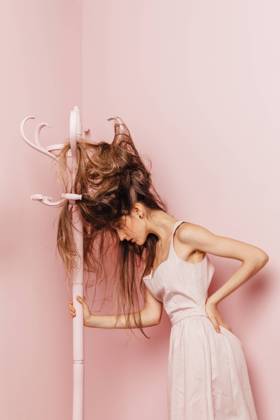 Front view of a teenage girl with tangled hairs on pink background, Model released, Property released Copyright: xMarcosxOsoriox MR