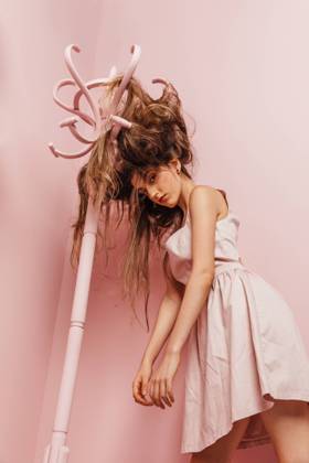Front view of a teenage girl with tangled hairs on pink background, Model released, Property released Copyright: xMarcosxOsoriox MR