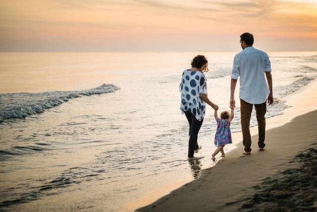 Family walking on beach Copyright: xPatriciaxBecarotox Model Released
