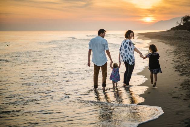 Family walking on beach Copyright: xPatriciaxBecarotox Model Released