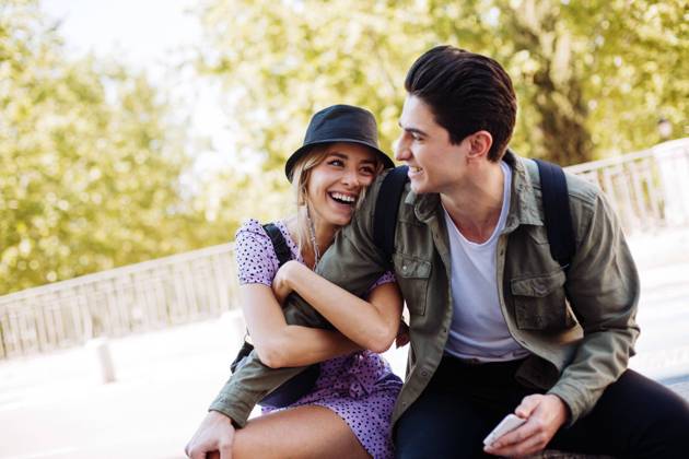 Young cheerful couple in casual clothes having fun during dating outdoors, Model released Copyright: xRamonxLopezx MR