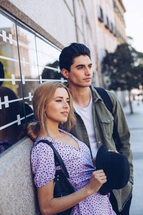 Young cheerful couple in casual clothes having fun during dating outdoors standing next to each other, Model released Copyright: xRamonxLopezx MR