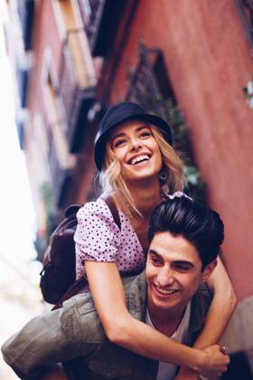 Young cheerful couple in casual clothes having fun during dating outdoors, Model released Copyright: xRamonxLopezx MR