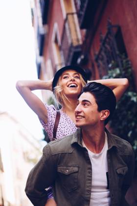 Young cheerful couple in casual clothes having fun during dating outdoors, Model released Copyright: xRamonxLopezx MR
