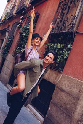 Young cheerful couple in casual clothes having fun during dating outdoors, Model released Copyright: xRamonxLopezx MR