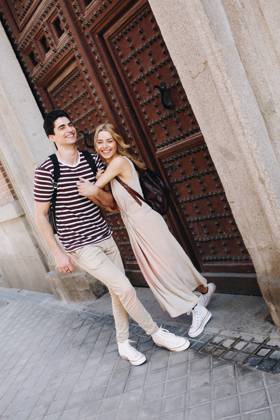 Young cheerful couple in casual clothes having fun during dating outdoors, Model released Copyright: xRamonxLopezx MR