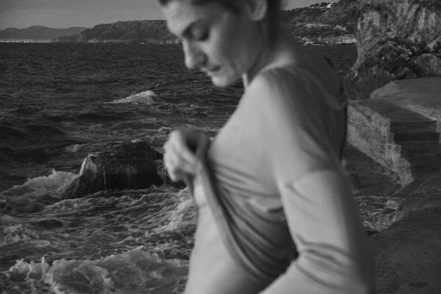 Woman taking off sweater near sea Copyright: xJeroxForradellasx Model Released