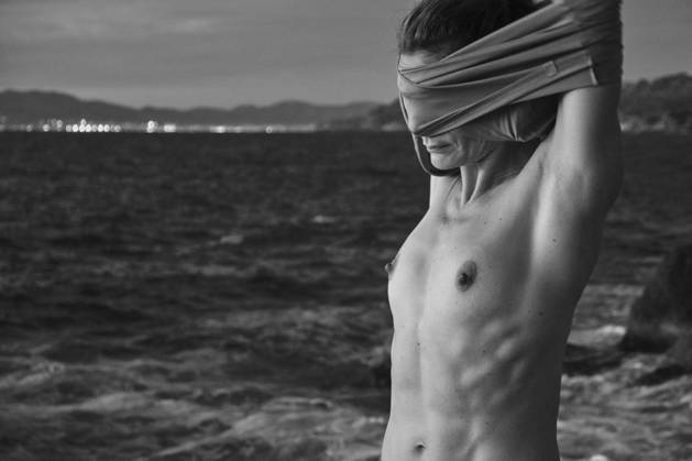 Woman taking off sweater near sea Copyright: xJeroxForradellasx Model Released