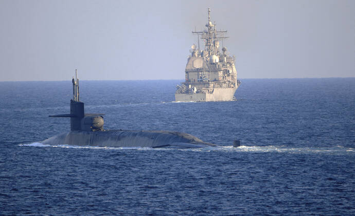 Bahrain: The U.S. Navy nuclear-power Ohio-class guided-missile submarine USS Georgia transits the Arabian Gulf alongside the Ticonderoga-class guided-missile cruiser USS Port Royal December 21, 2020 off the coast of Bahrain. Arabian Sea Bahrain - ZUMAp138 20201221_zaa_p138_011 Copyright: xMc2xIndraxBeaufort U.S.xNavyx